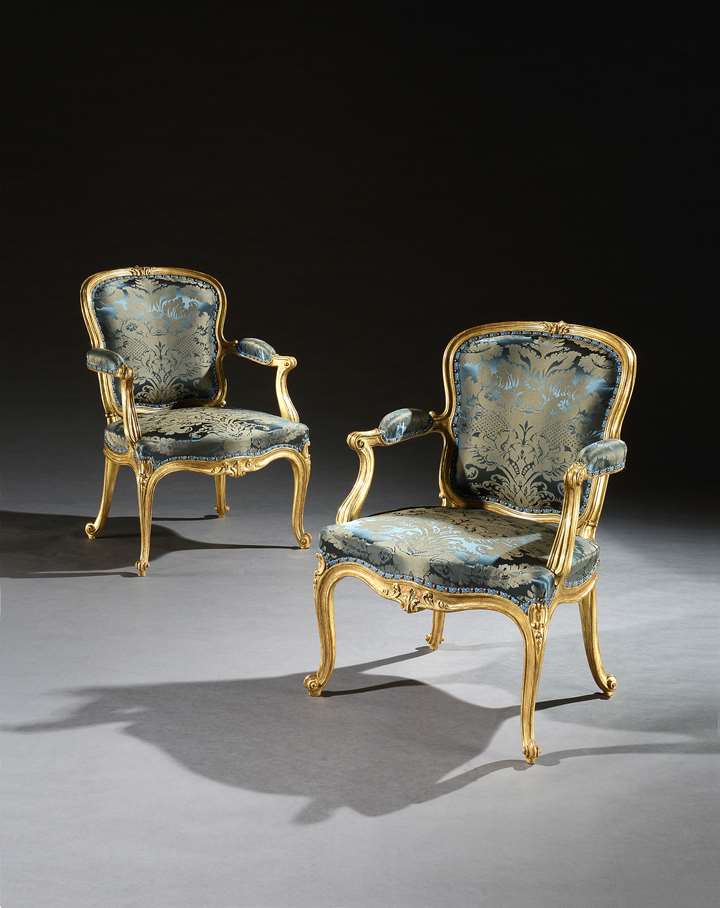 An Exceptional Pair of Giltwood Cabriole Armchairs